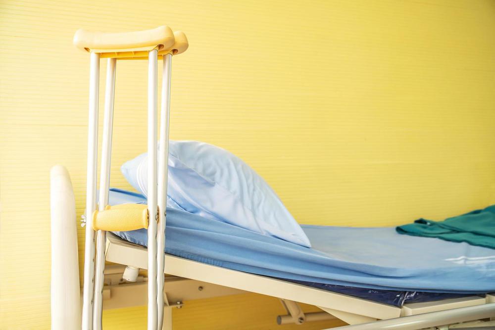 empty-bed-with-pillow-and-blanket-and-intravenous-stand-and-walking-stick-walking-stick-cane-used-by-disable-patient-for-balancing-healthcare-medical-insurance-and-physical-therapy-concept-free-photo